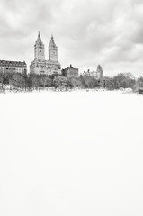  Bleak monochrome view of the Upper West Side skyline above the frozen Central Park Lake after a winter storm in New York City