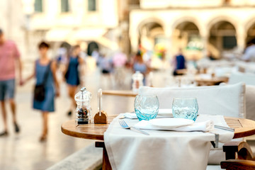 Wall Mural - Glasses table setting in a summer restaurant