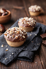 Wall Mural - Sweet chestnut cups filled with soft curd cheese, chestnut puree and ground almonds, topped with chocolate frosting and chopped nuts