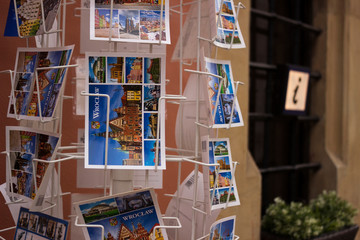 Wroclaw, Poland - October 31, 2019. Postcards depicting Wroclaw sights on a metal rack in the city center. Purchase of postcards by memory