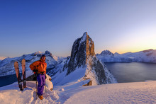 Skitouring Man Standing At The Ridge In Front Of The Iconic Segla Mountain, View Of The Ocean Fjords, Fjordgard, Norway