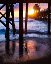 Sunset At The Sea Underneath Pier