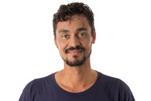 Mixed Race Man Looking Happily In Camera. Standing Against White Background.