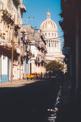 Wall Mural - Old colorful buildings on a street leading to the Capitol building in Havana