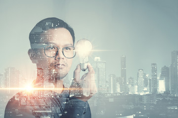 Leinwandbilder - double exposure of businessman holding light bulb. idea concept with innovation and inspiration Creativity and innovative are keys to success.Concept of new idea and innovation with light bulbs.