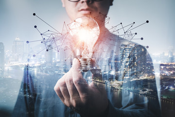 Leinwandbilder - double exposure of businessman holding light bulb. idea concept with innovation and inspiration Creativity and innovative are keys to success.Concept of new idea and innovation with light bulbs.