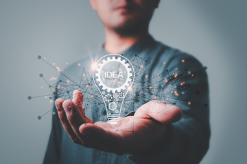 Leinwandbilder - businessman holding light bulb. idea concept with innovation and inspiration Creativity and innovative are keys to success.Concept of new idea and innovation with light bulbs.