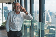 © Mongkolchon - business background of senior top executive having business talk with smartphone in office