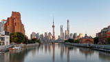 Fototapeta Nowy Jork - beautiful shanghai bund viewed from suzhou river in evening with moon and blue sky background, including many famous landmarks in Shanghai.