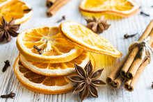 Christmas Spices - Cinnamon Sticks, Star Anise, Cloves And Slices Of Dried Orange On Old Wooden Background.