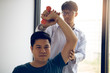 © wutzkoh - Asian physiotherapists help raise arms for patients to raise dumbbells through his rehabilitation in the clinic.