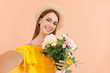 © Pixel-Shot - Beautiful young woman taking selfie with bouquet of carnation flowers on color background