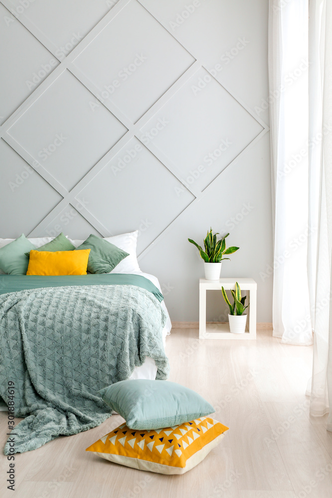 Big comfortable bed with pillows in room