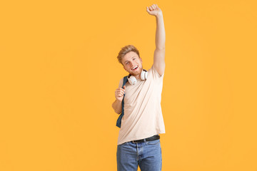 Poster - Portrait of happy male student on color background