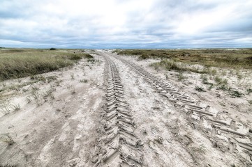 Poster - High angle shot of a country road covered in snow during wintertime