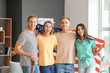© Pixel-Shot - Happy young friends with national flag of USA at home