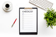 Checklist on white office background top view