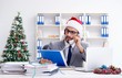 © Elnur - Young businessman celebrating christmas in the office