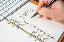 Close-up Of A Businessman's Hand Writing Goals And List In The Diary.