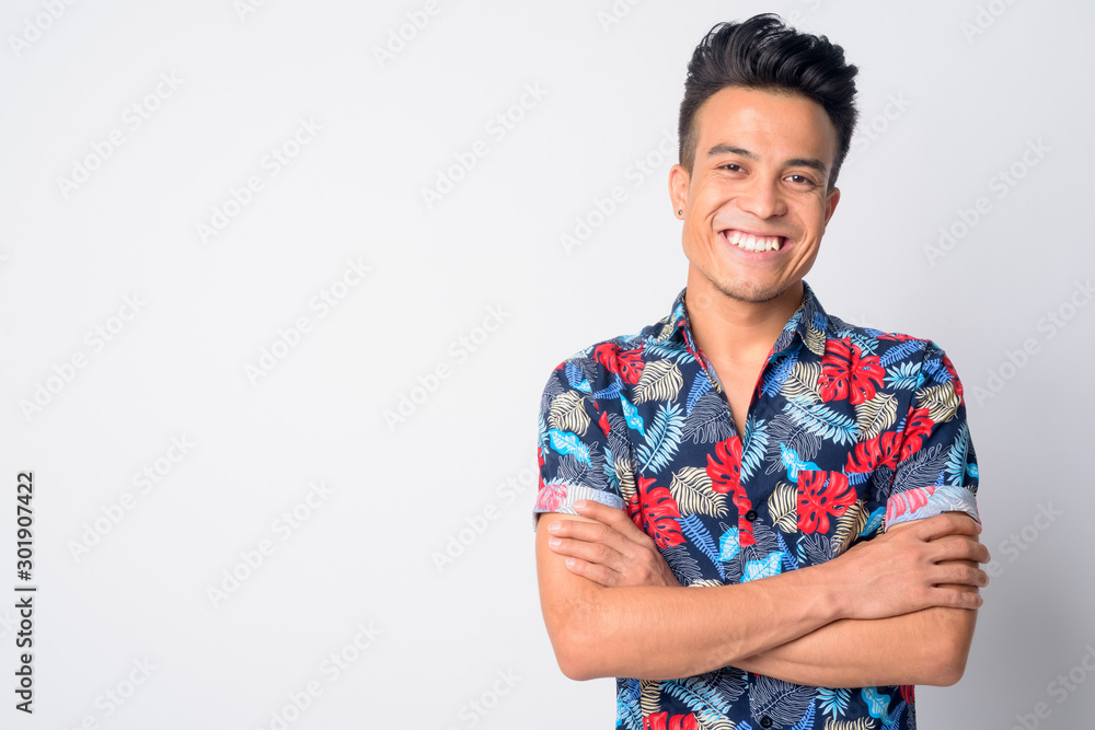 Portrait of happy young Asian man smiling with arms crossed - obrazy, fototapety, plakaty 