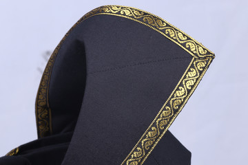 A Malay black coloured with gold lace traditional 