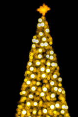 Wall Mural - Blurred and bokeh of Christmas lighting on Christmas tree and black background.