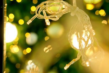 Wall Mural - Blurred of Christmas lights on blurry and bokeh of Christmas lighting  background.