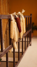 Ripe Dried Corn Cobs Hanging On The Old Wooden Balcony - Agriculture Concept