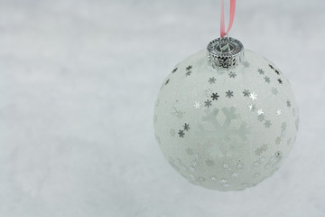 White christmas ball on light background.