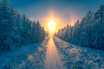 Wall Mural - Snowy winter railroad view. First snow sunset landscape. Photo from Sotkamo, Finland.