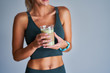 © Kalim - Adult woman drinking healthy smoothie after workout