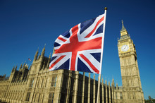 Single Union Jack Flag Waving In Front Of Big Ben At The Houses Of Parliament In London, UK On A Clear Sunny Day