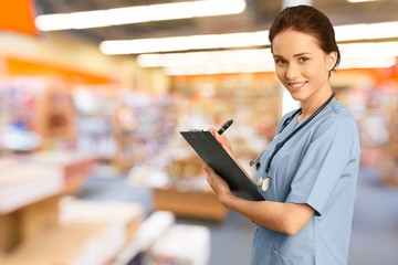 Poster - Attractive young female doctor student on background