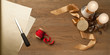 christmas wooden table with red and golden ribbon and candles. Horizontal composition with copy space right in the middle.