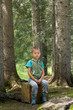 child meditates surrounded by nature