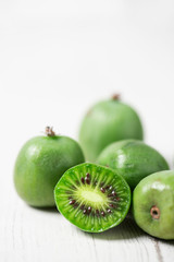 Poster - ripe kiwi berries on a white table