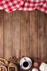 Poster - cup of coffee and beans on wooden background