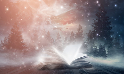 an open book on a wooden table under the night sky against a dark forest. magical radiance. night sc