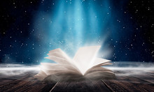 An Open Book On A Wooden Table Under The Night Sky Against A Dark Forest. Magical Radiance. Night Scene.