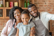 © Prostock-studio - Portrait of happy family taking selfie over kitchen background