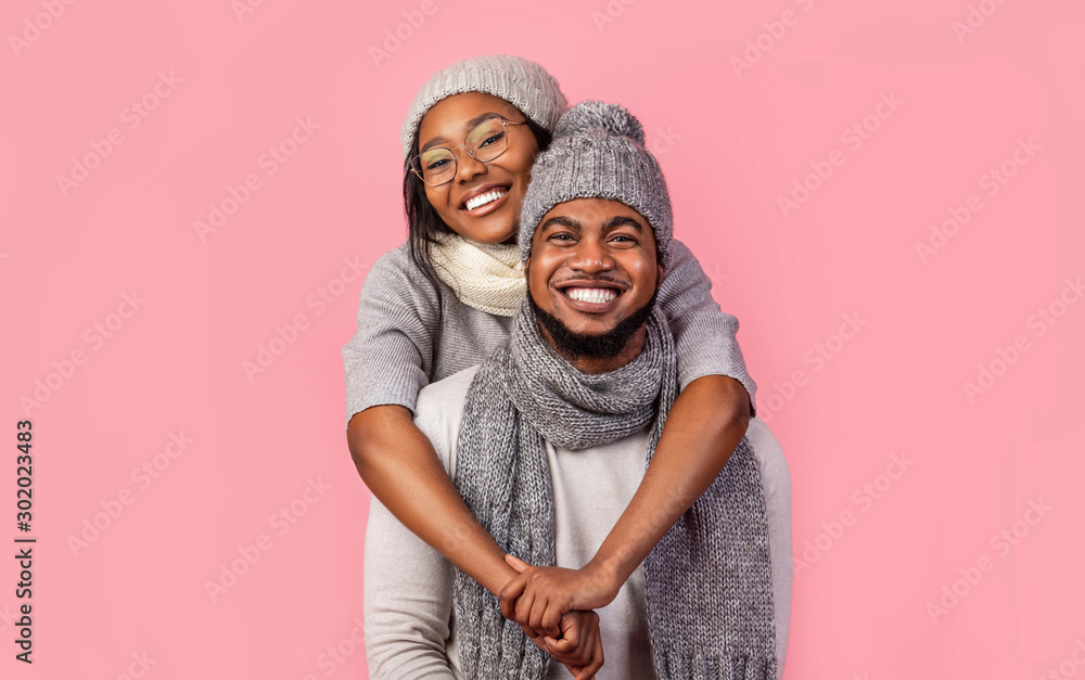 Happy african woman hugging her man from behind, winter set Stock Photo ...