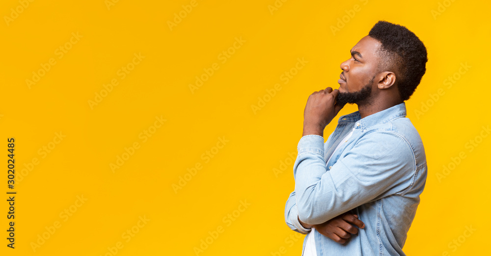 Young african american guy thinking about something over yellow background - obrazy, fototapety, plakaty 