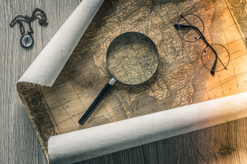 Old colonial map of South America with a magnifying glass, compass and period glasses.  Vintage style