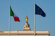 The Italian and Union European flag with in the background a gold Christ statue