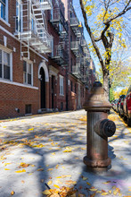 Old Fire Hydrant On A Sidewalk By Old Residential Buildings In Astoria Queens New York During Autumn