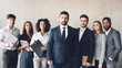 Millennial business colleagues headed with boss, posing to camera