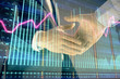 © Andrey - Multi exposure of forex graph on abstract background with two businessmen handshake. Concept of success on stock market