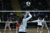 A player serves during a volleyball tournament