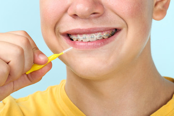 Wall Mural - Young man with toothbrush on blue background