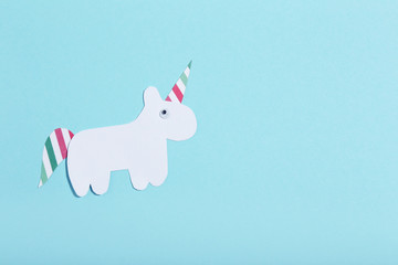 Sticker - Paper unicorn on blue background. Minimalism concept